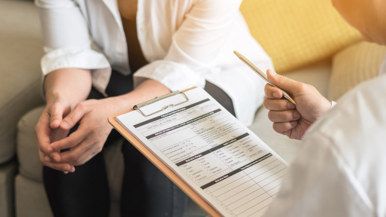 Consulting with a patient in reception area